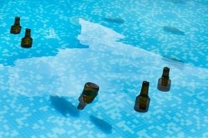 Beer Bottles Floating In A Pool.